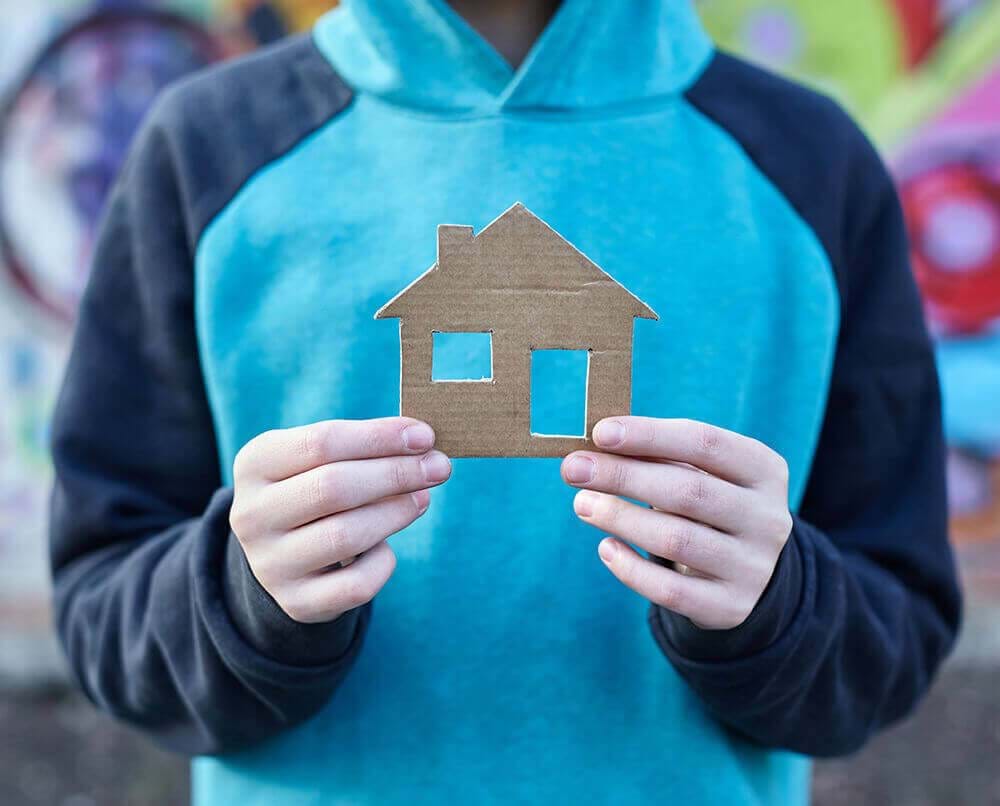 Person holding a cut out of a house