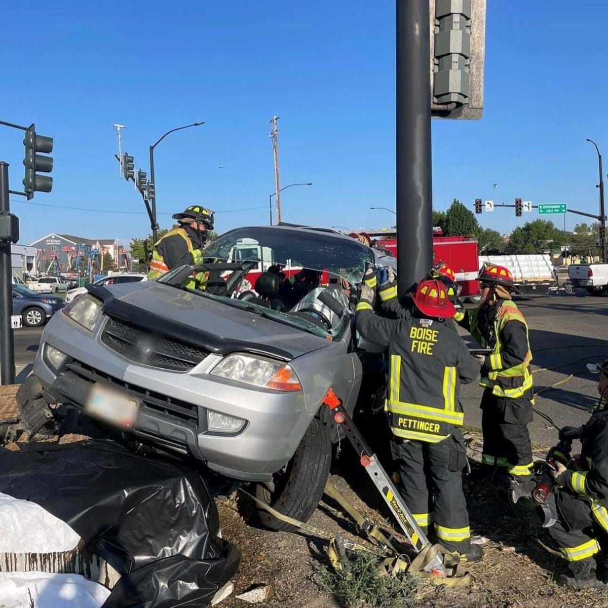 Firefighters helping at a vehicle crash.