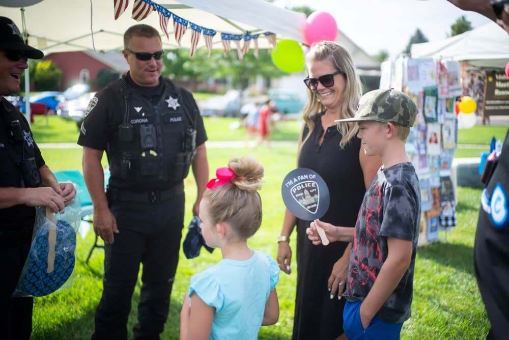 Two police officers meet a family at a National Night Out event