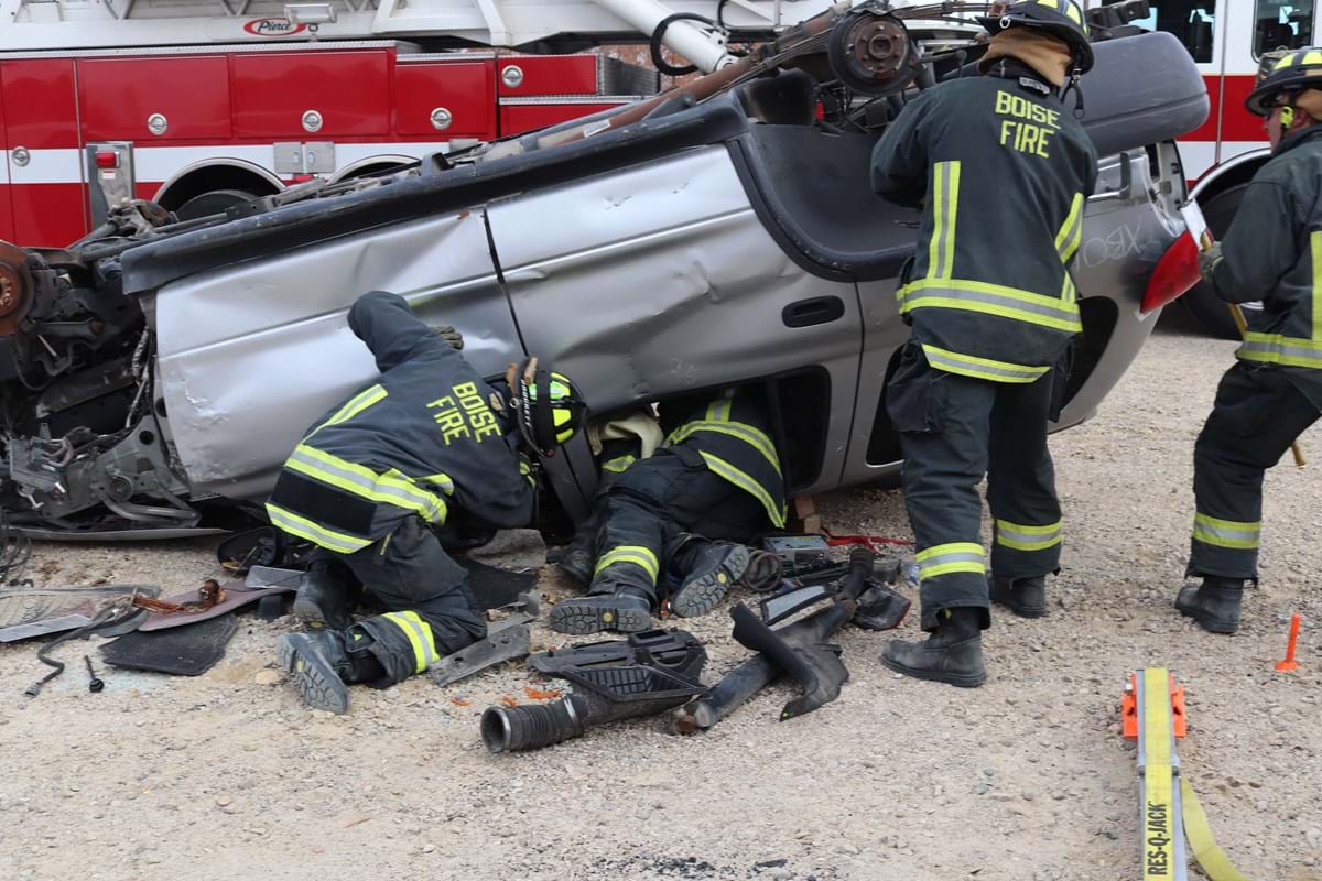 Vehicle flipped upside down with firefighters simulating an emergency save.