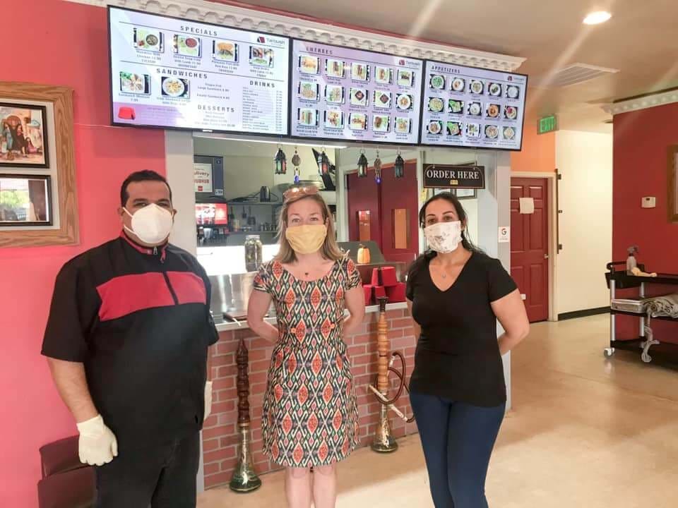 Mayor McLean standing in a restaurant with the owners