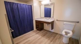 Bathroom with blue shower curtain, sink and toilet