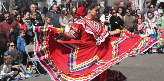 cultural dancer performing in front of crowd on a street