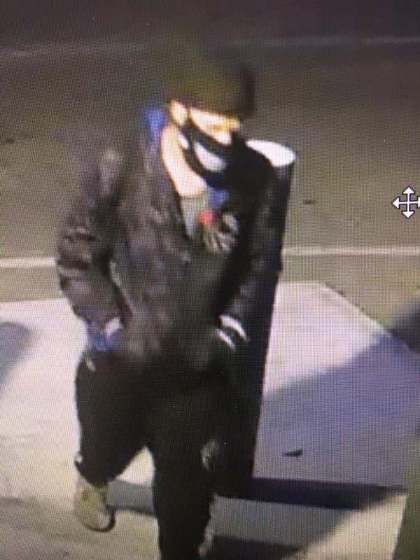 man with black/gray jacket, black sweatpants, a black hat and mask