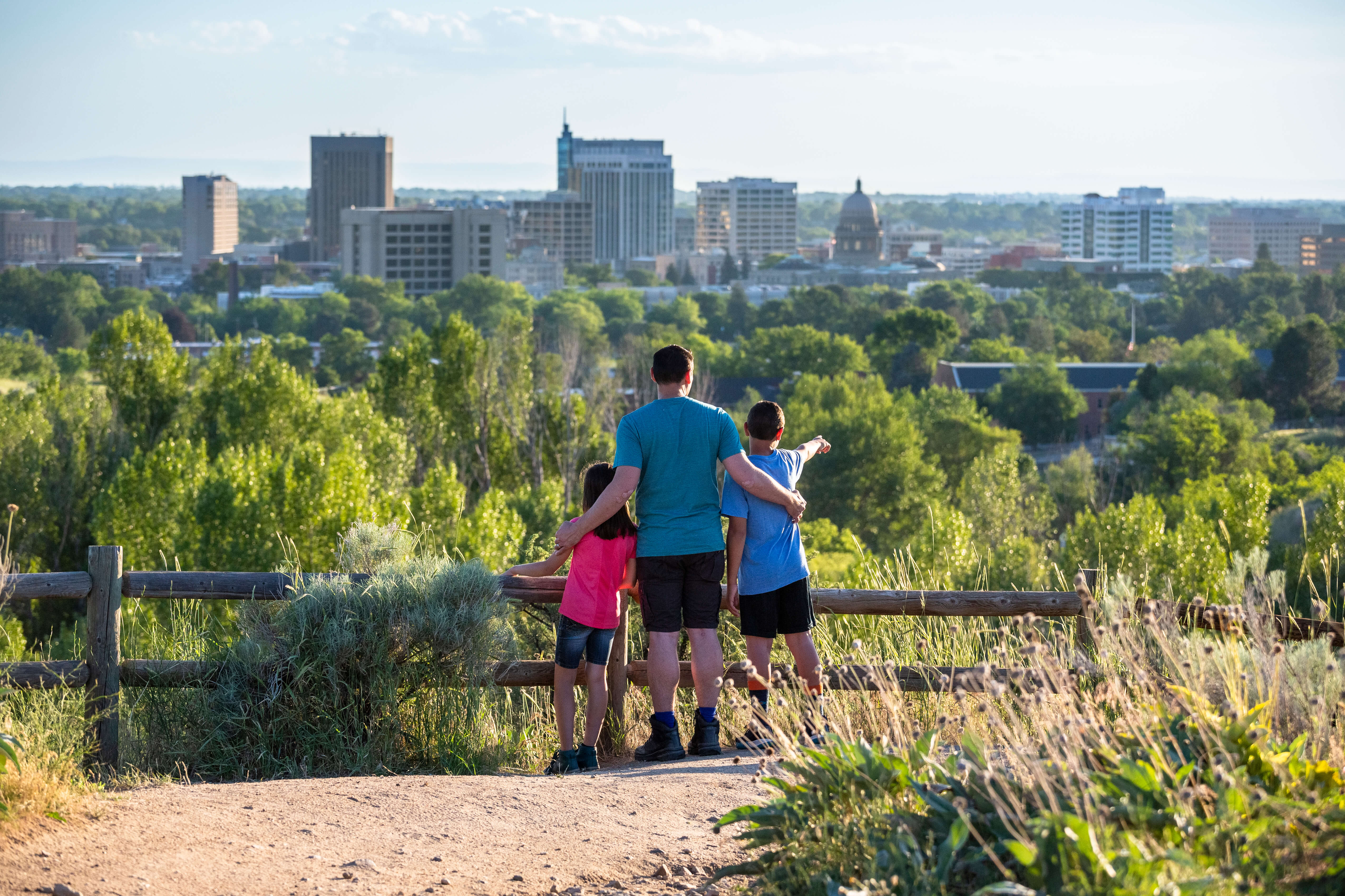 Three people looking at the downtown city skyline
