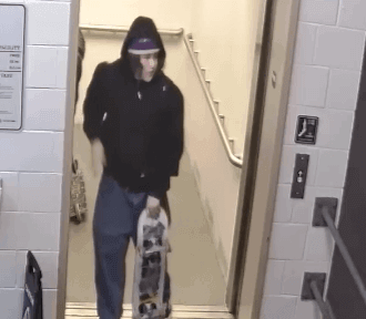 man in black hoodie leaving elevator