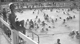 Group of children swimming in south junior high swimming pool in the summer.