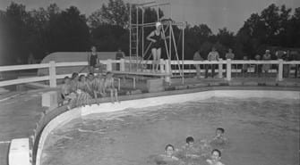 Group of children swimming in lowell pool in the summer.