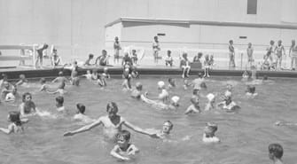 Group of children swimming in south junior high swimming pool in the summer.