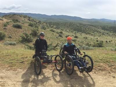 Two gentleman on handbikes in the boise foothills on a cool spring day.