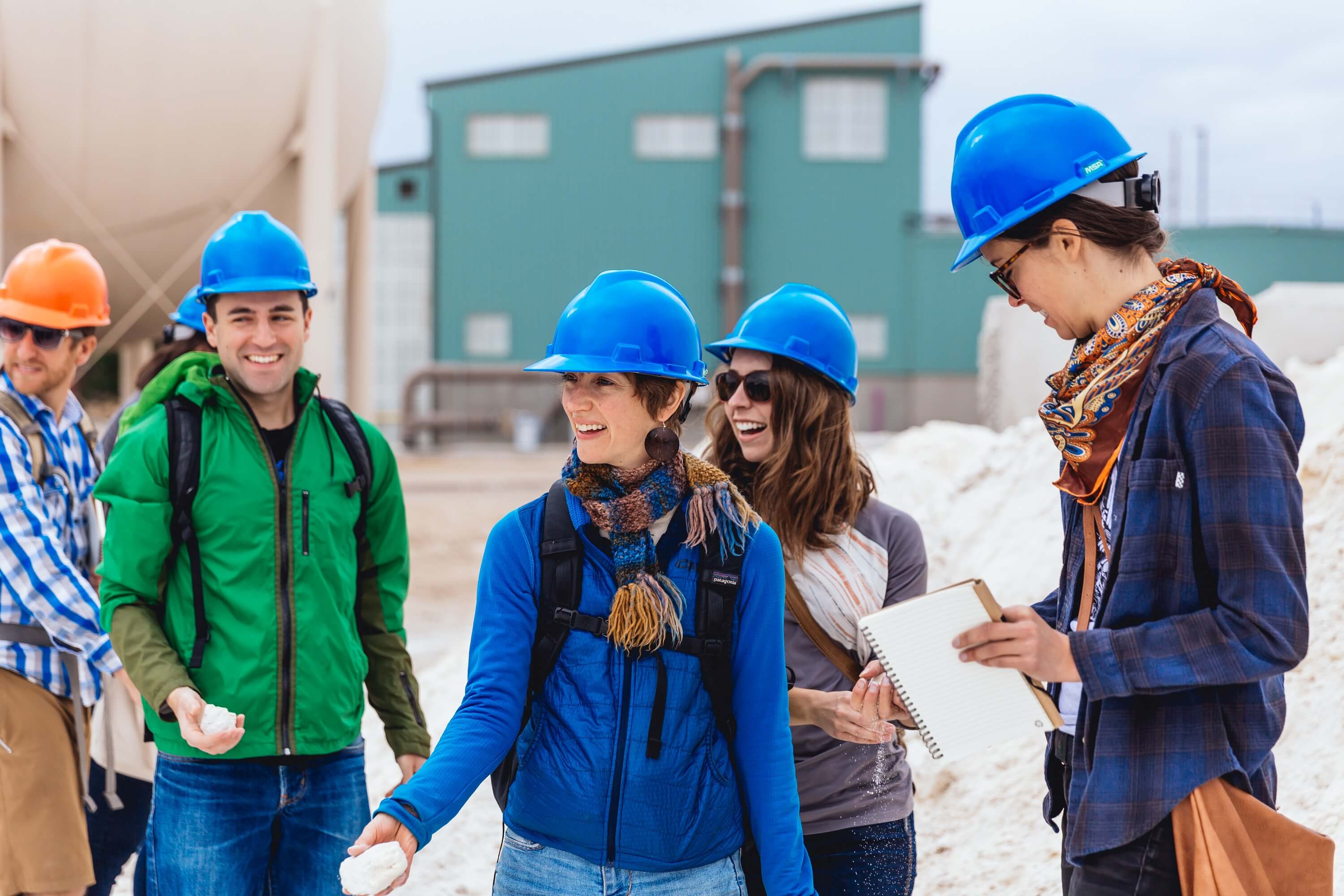 A group of people with hard hats on.