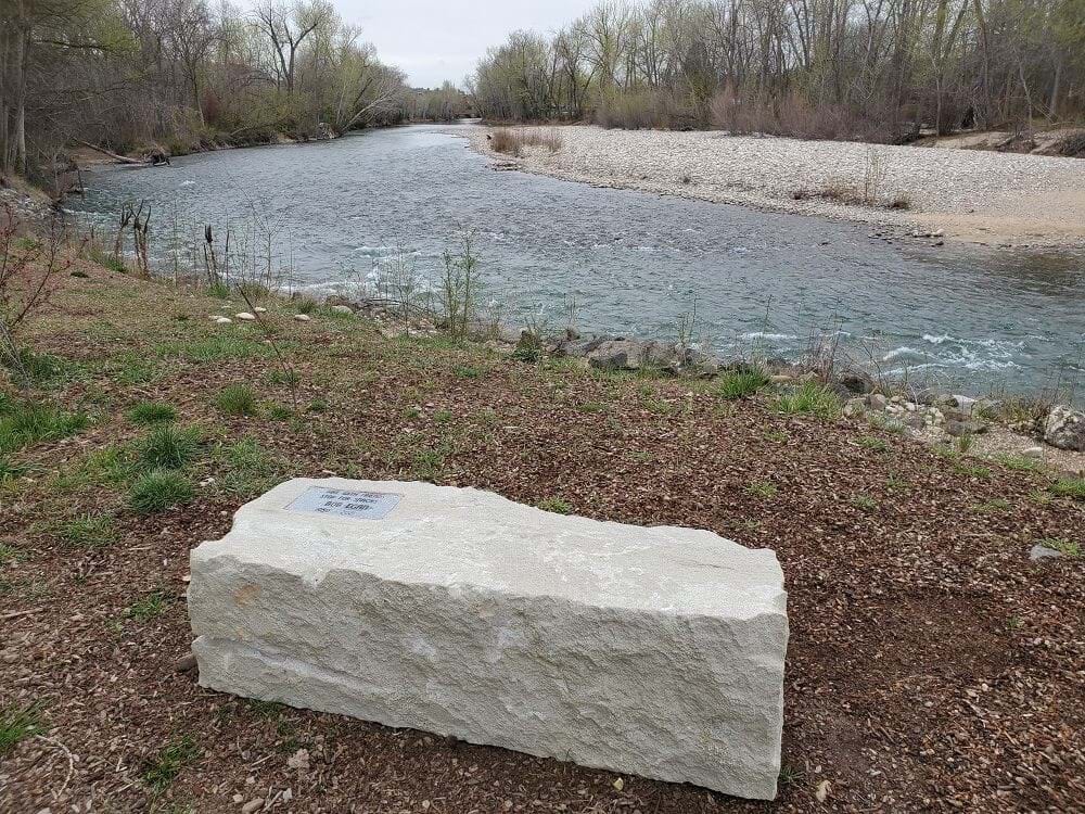 Stone memorial bench along the Boise River
