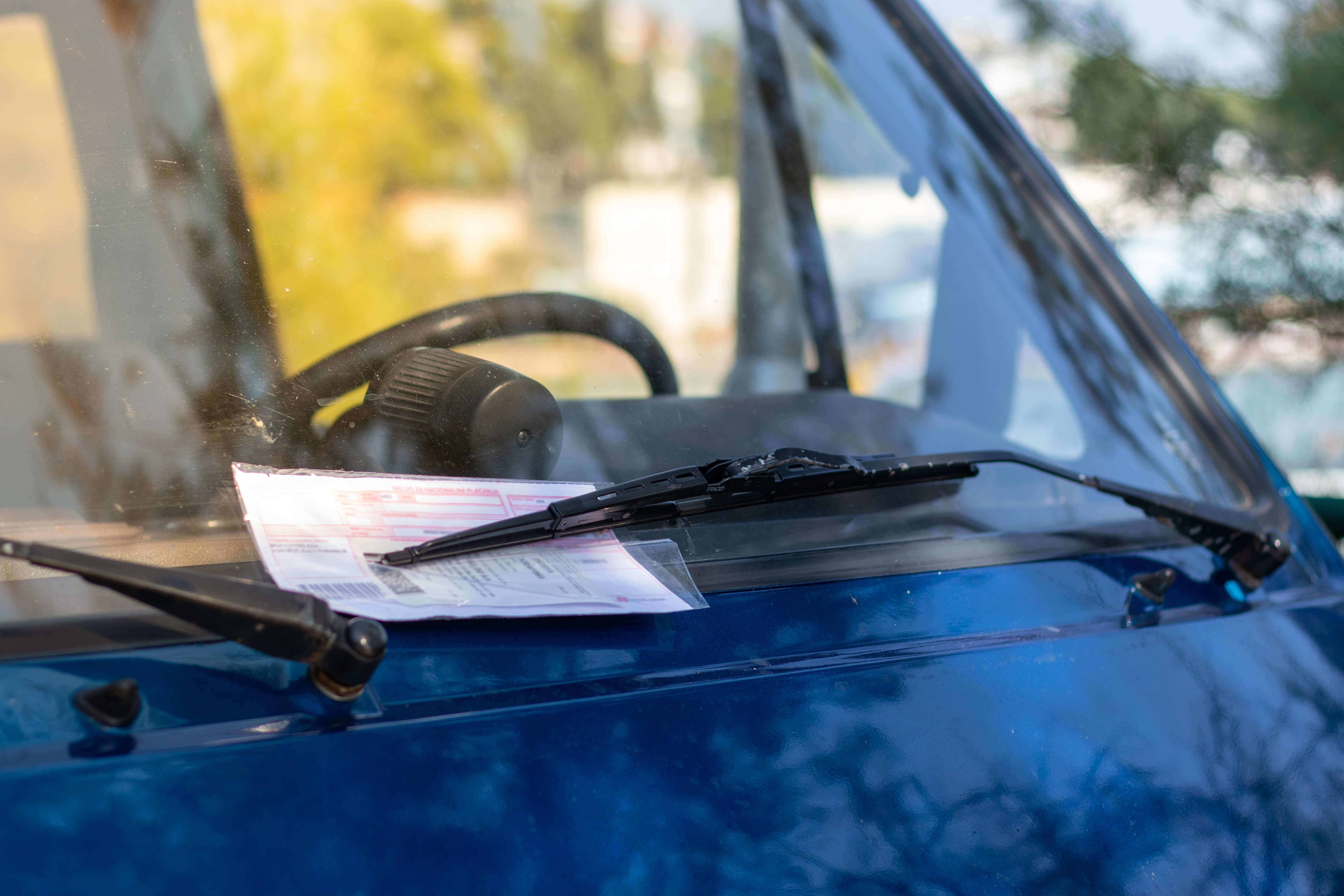 a parking violation on a windshield of a car