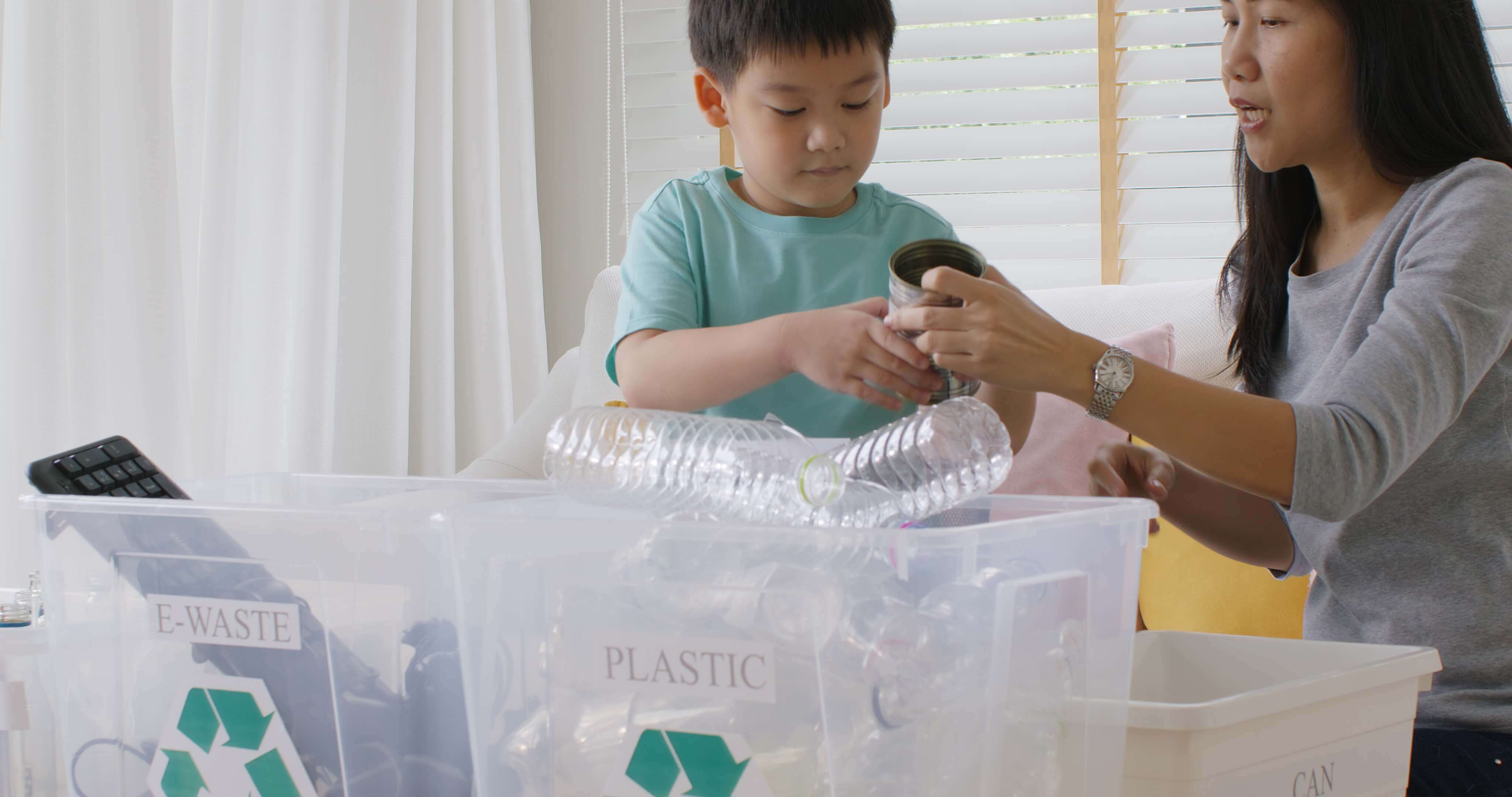 boy and his mother sorting recycling and trash