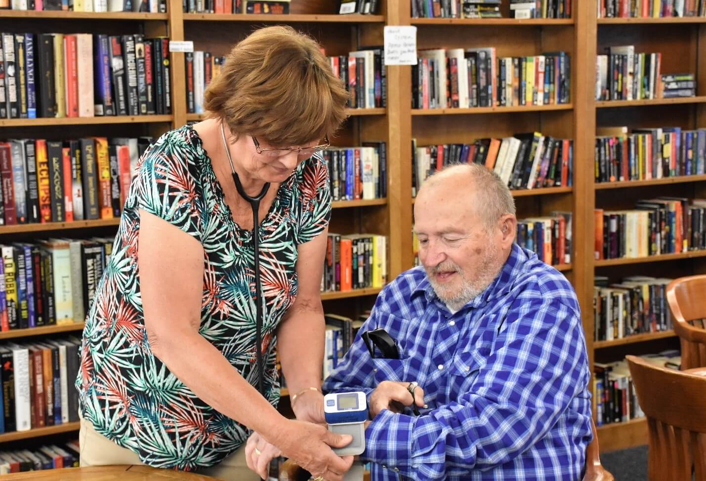 Woman helping an elder man at the Dick Eardley Senior Center