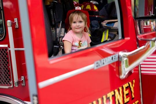 Little girl in a fire engine