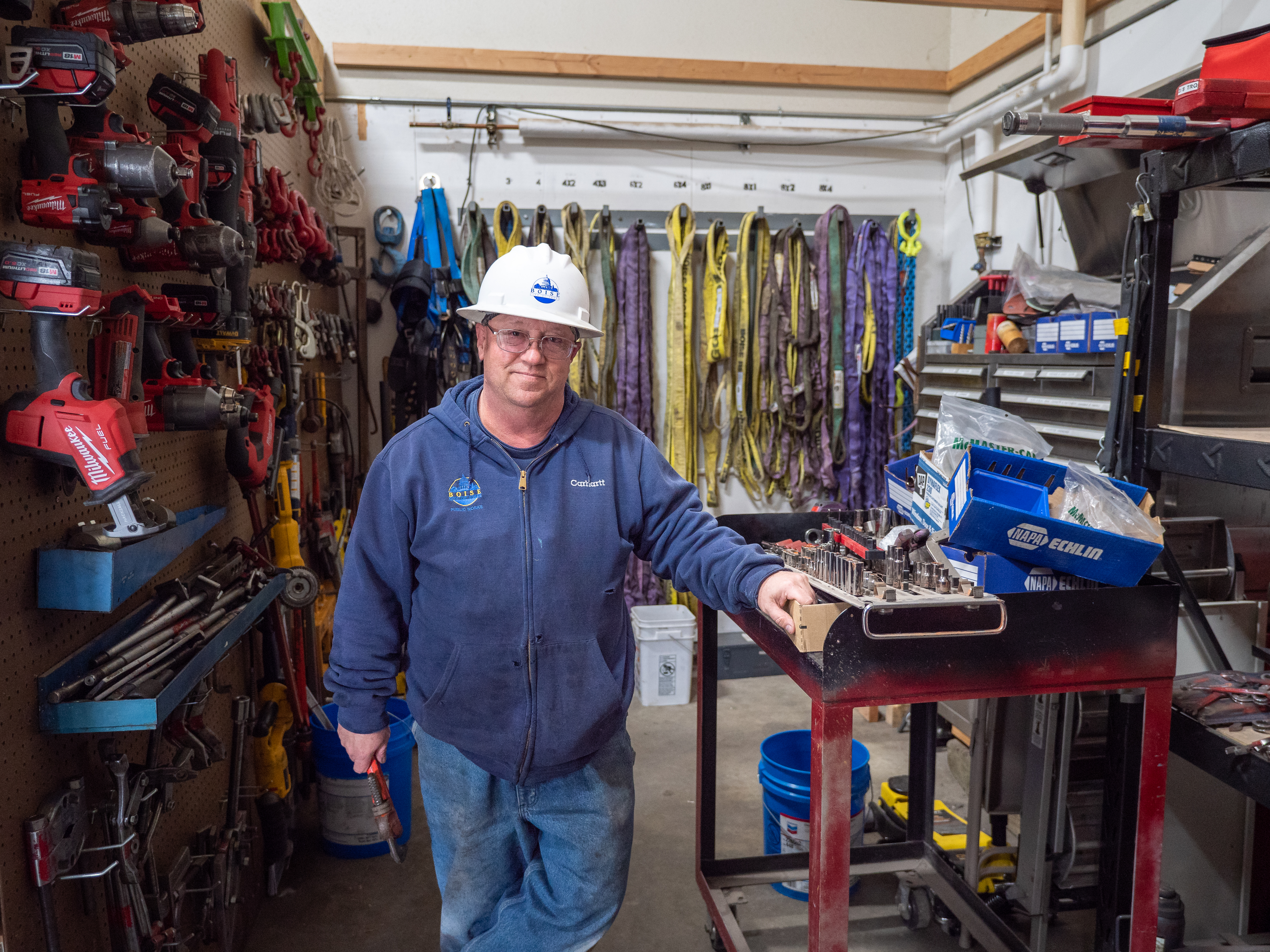 A mechanic in front of a tool room.