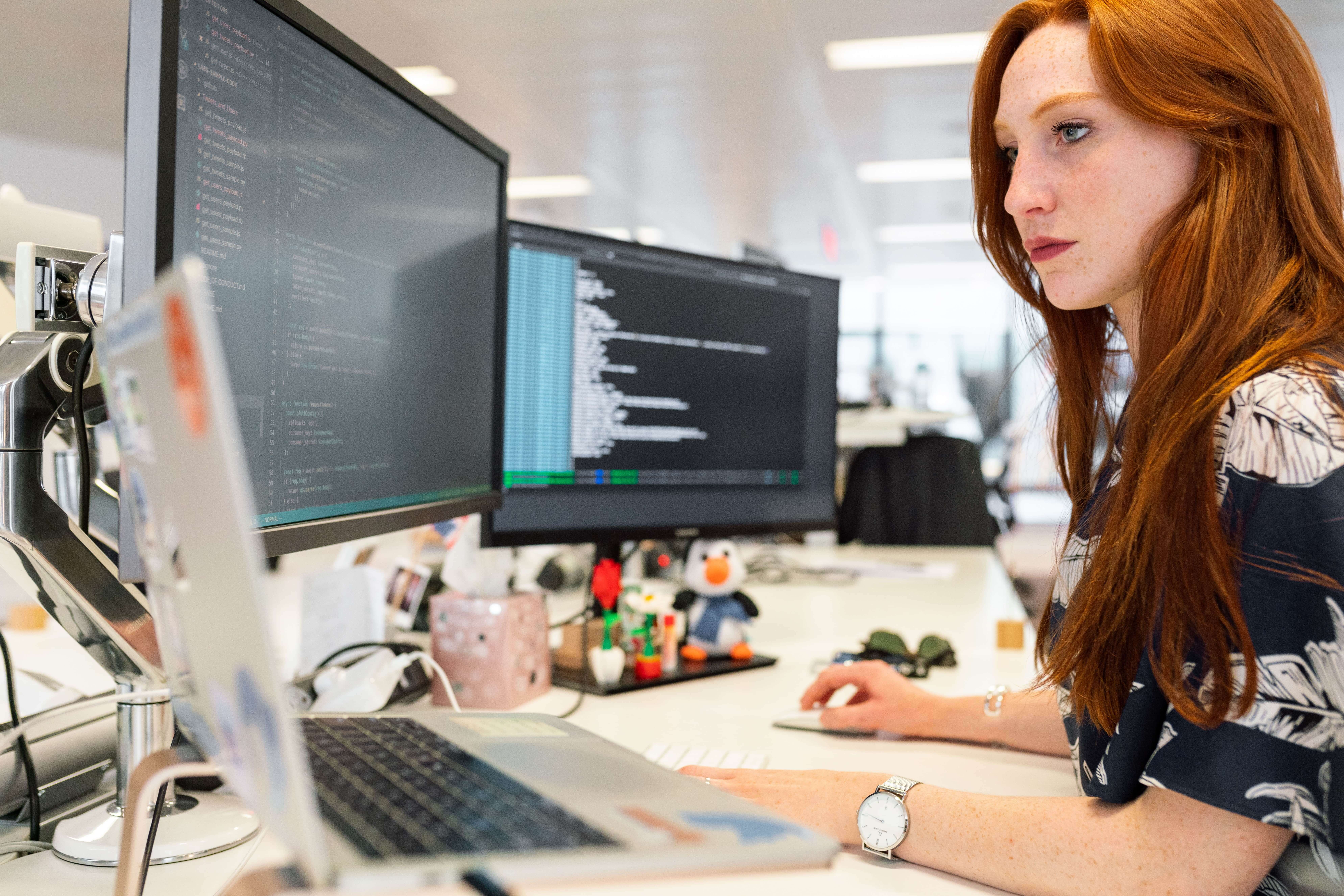A programmer works at a computer.