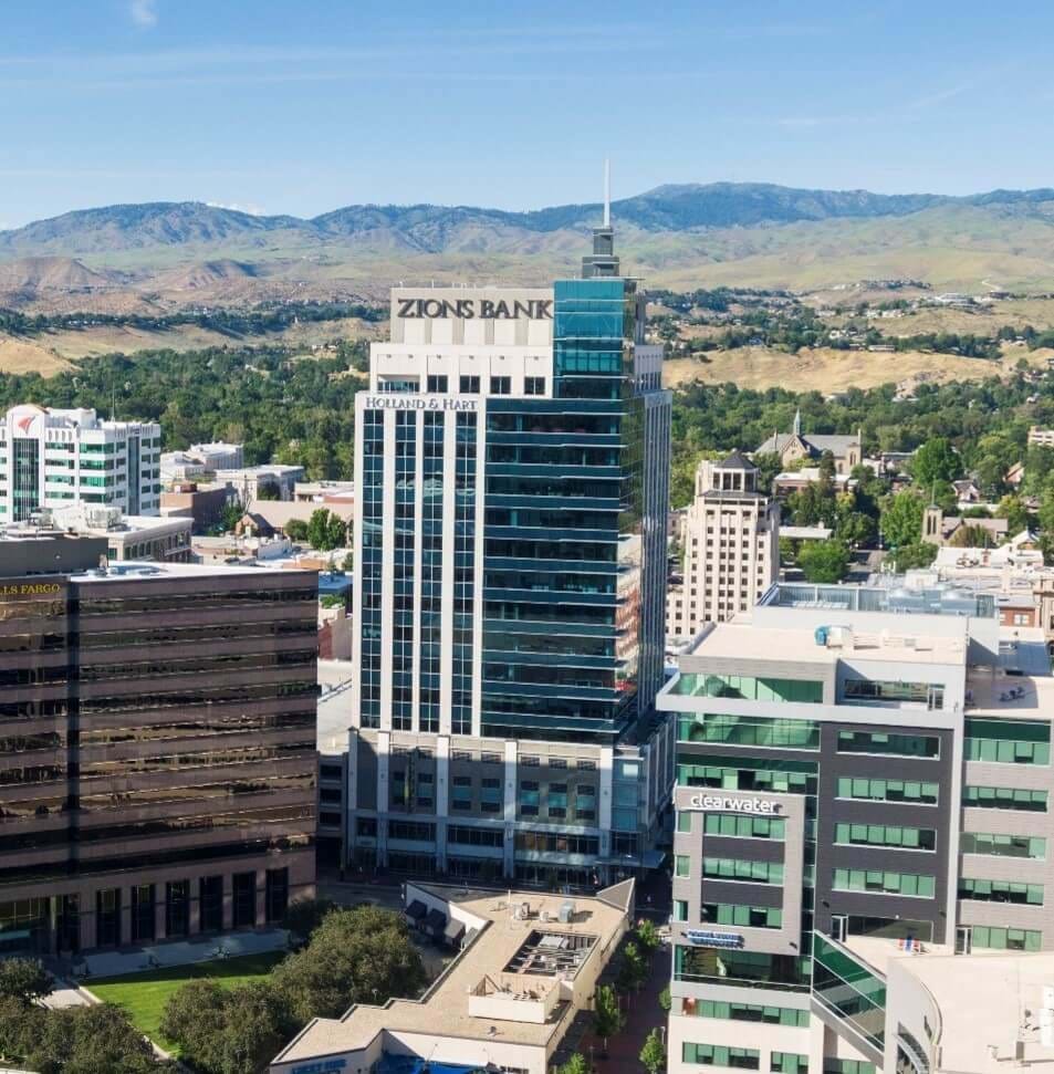 Multi story buildings in downtown with foothills in background