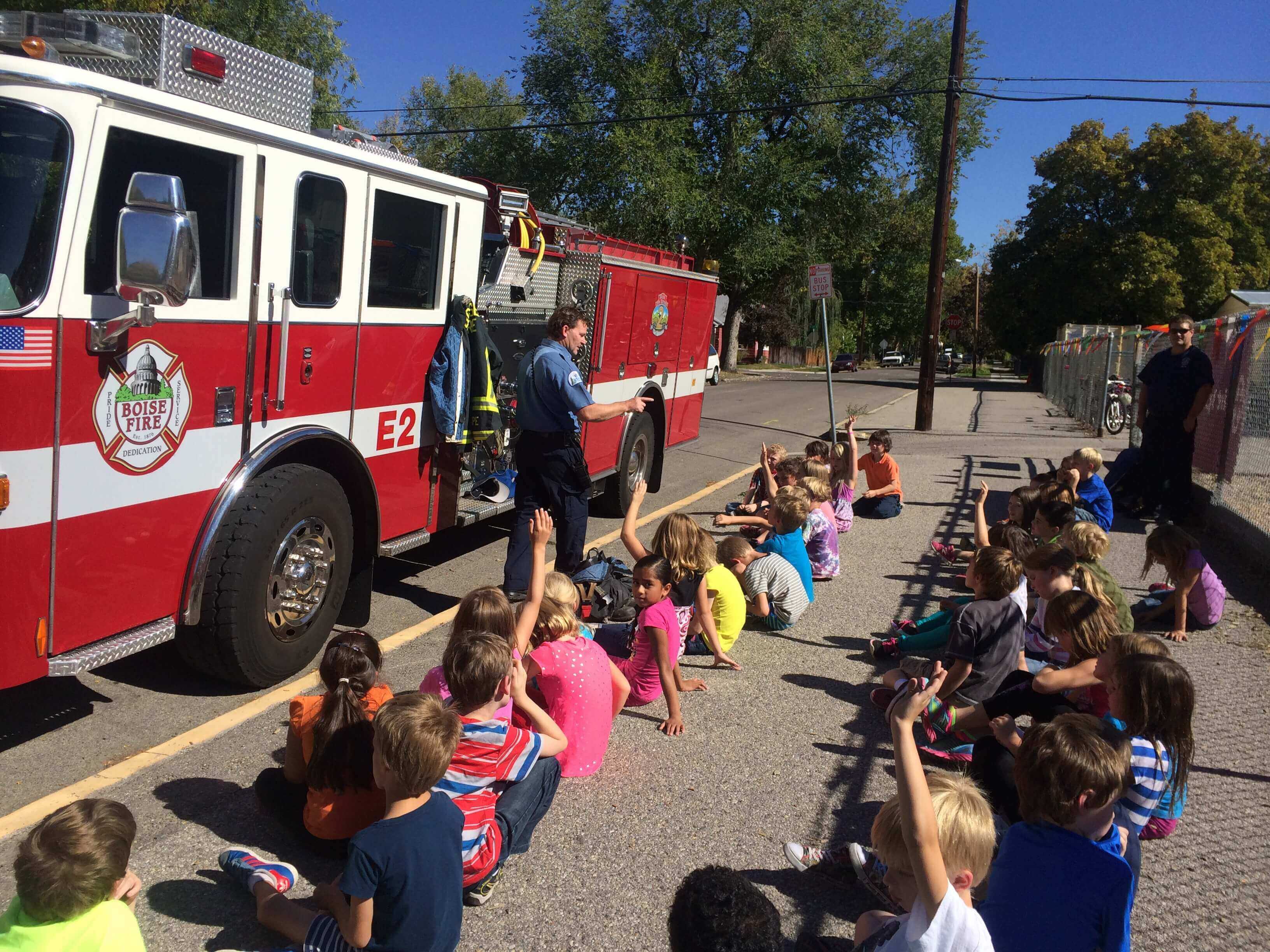 A fire preparedness demonstration is given to a group of children.
