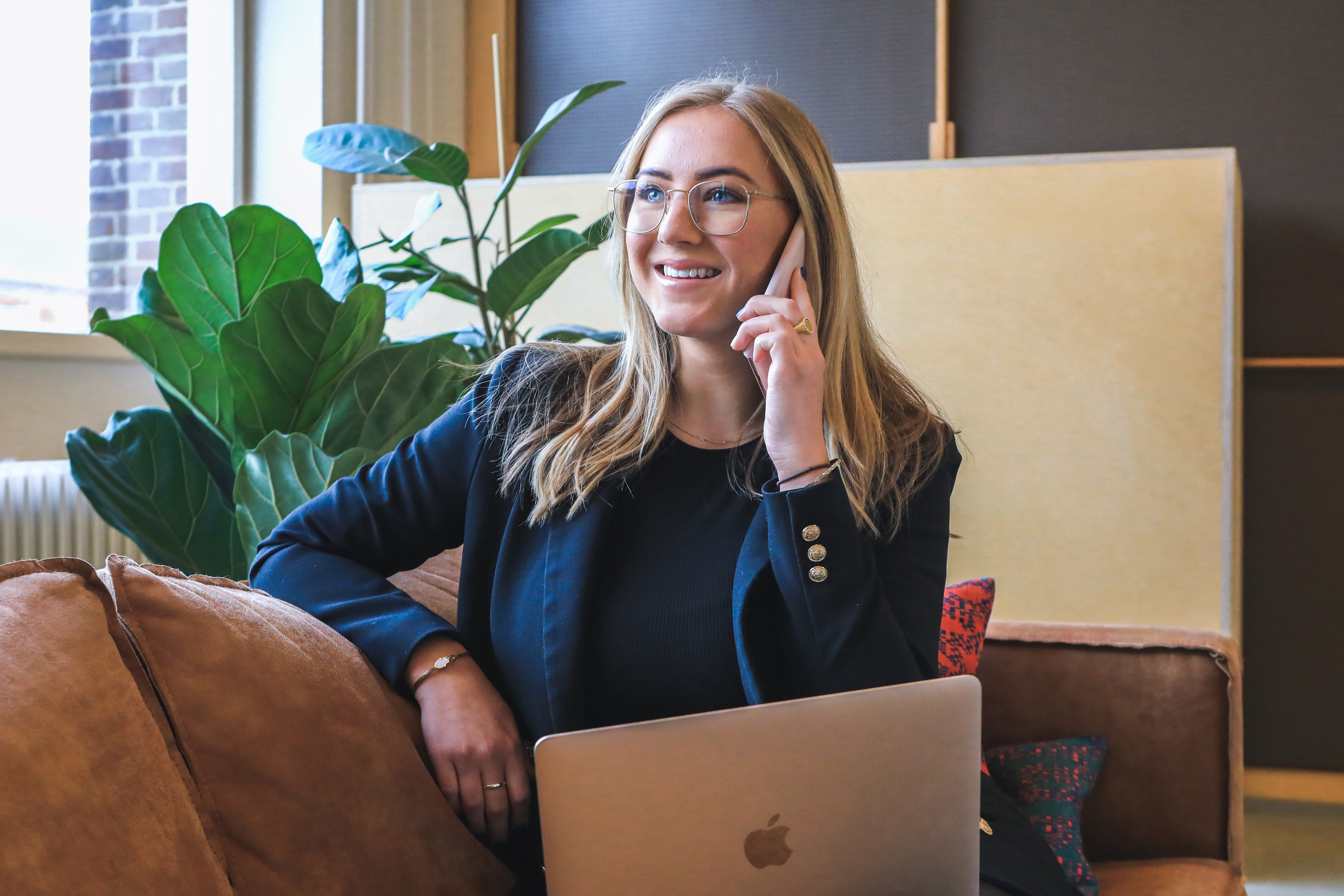 A woman talks on the phone in an office.