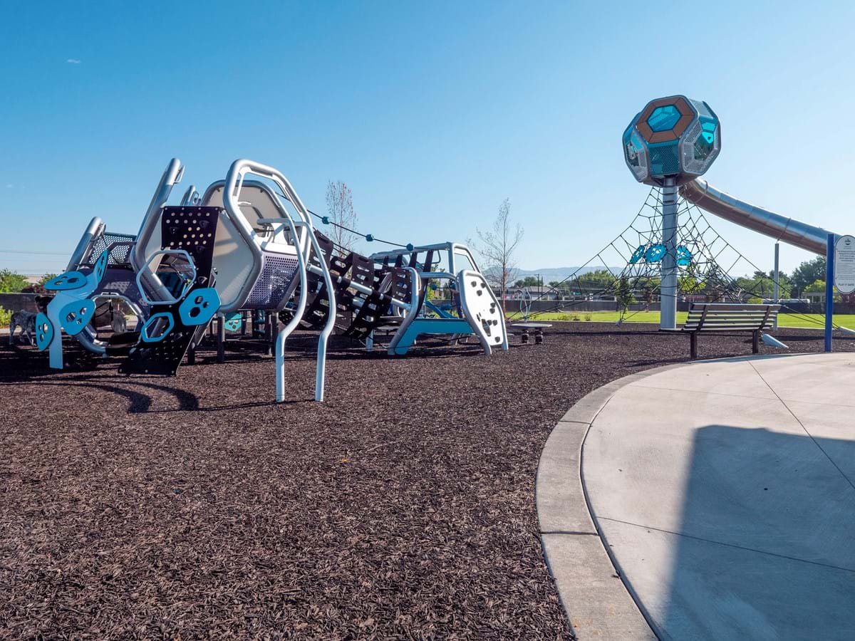 Franklin Playground with accessible equipment and brown bonded rubber on ground and blue skies
