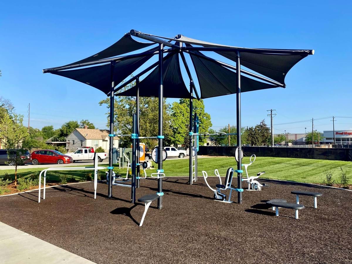 Franklin Park outdoor gym with brown bonded rubber on ground and blue skies