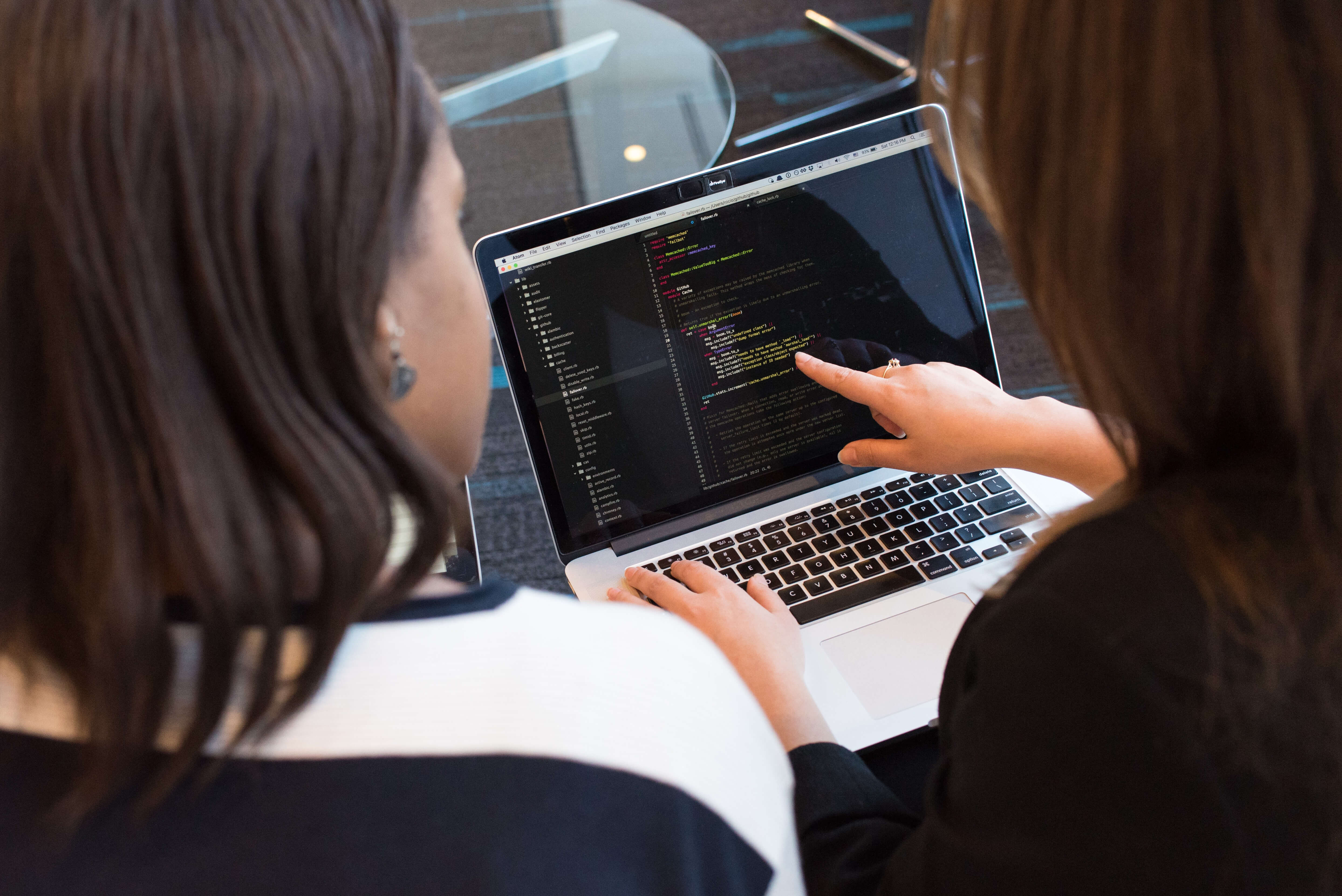 Two people working on an audit on a computer screen.