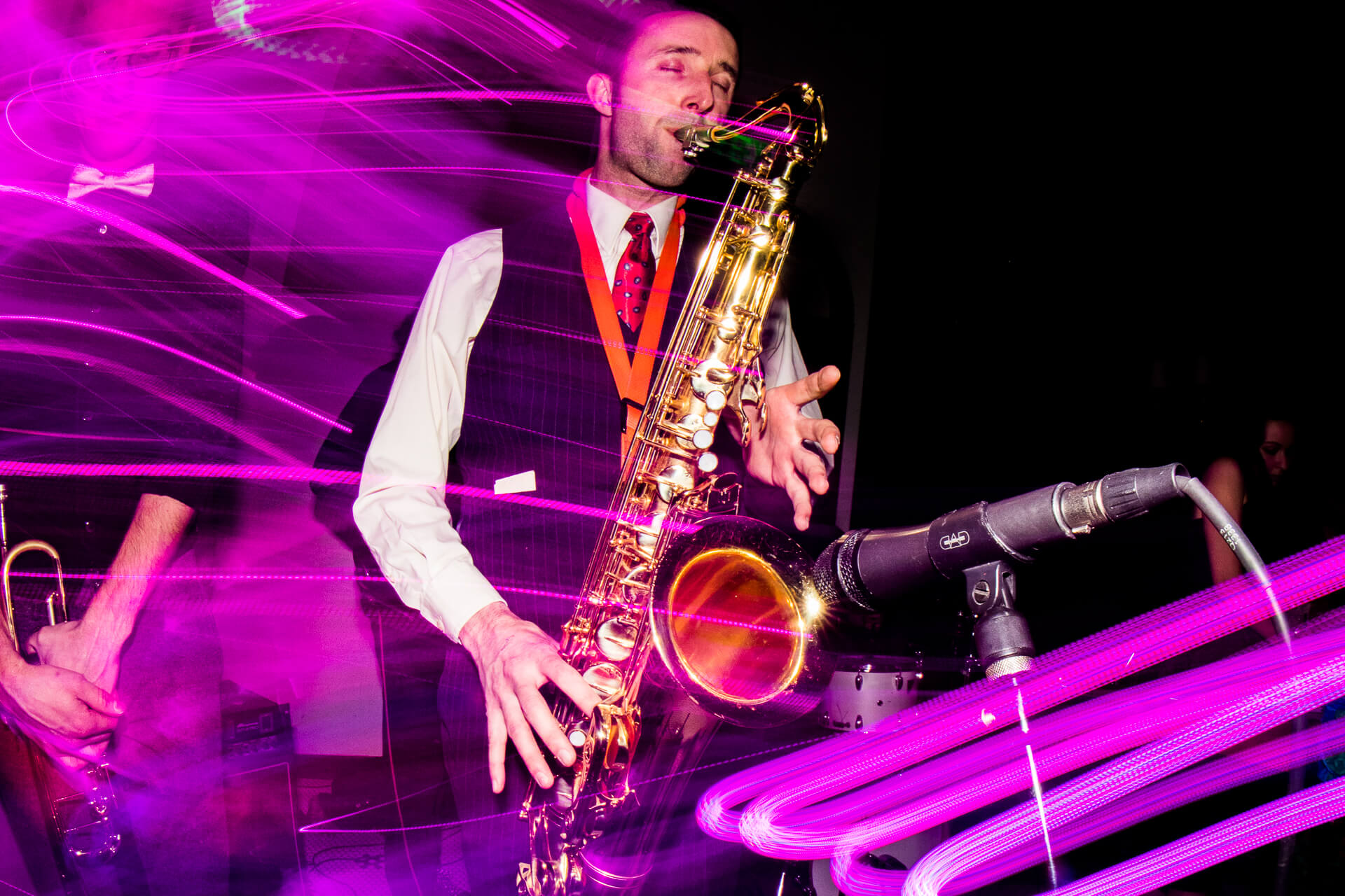 Saxophone player with purple lights around him