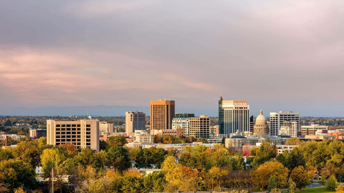 Boise skyline with downtown buildings and clouds above.