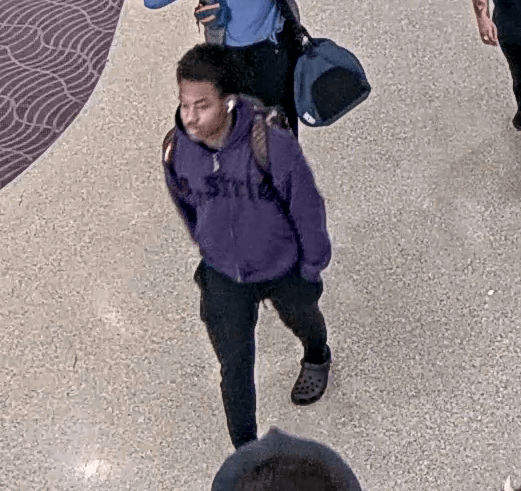 man wearing a backpack in the airport