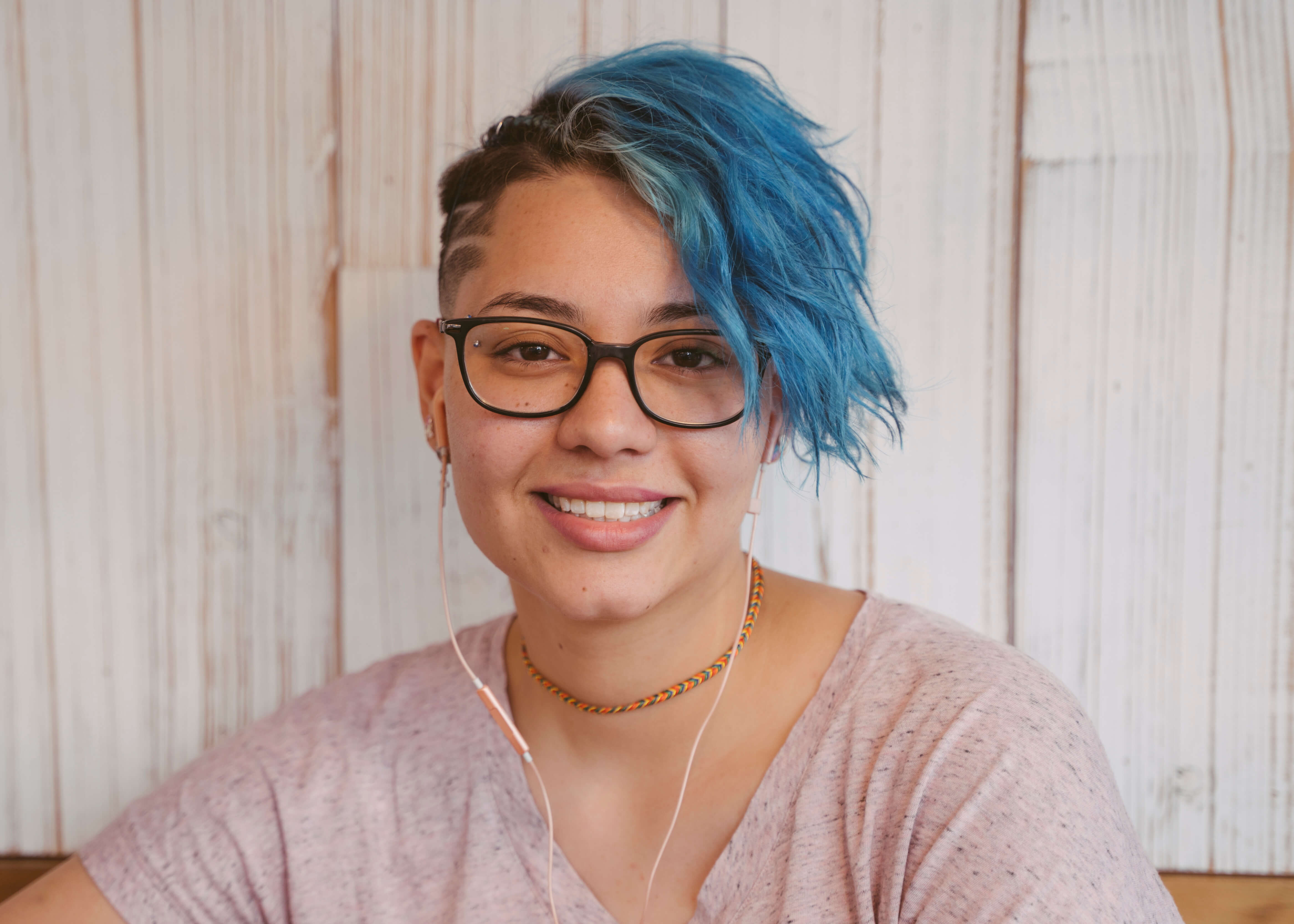 Girl with blue hair listening to mustic
