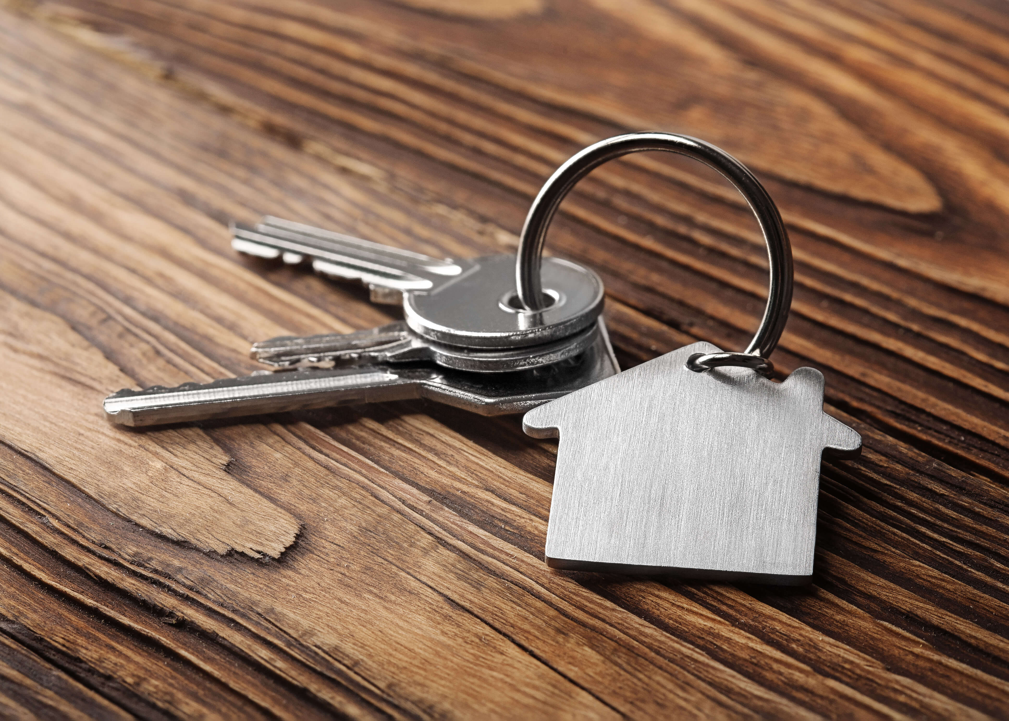 A set of keys with a keychain on a desk.