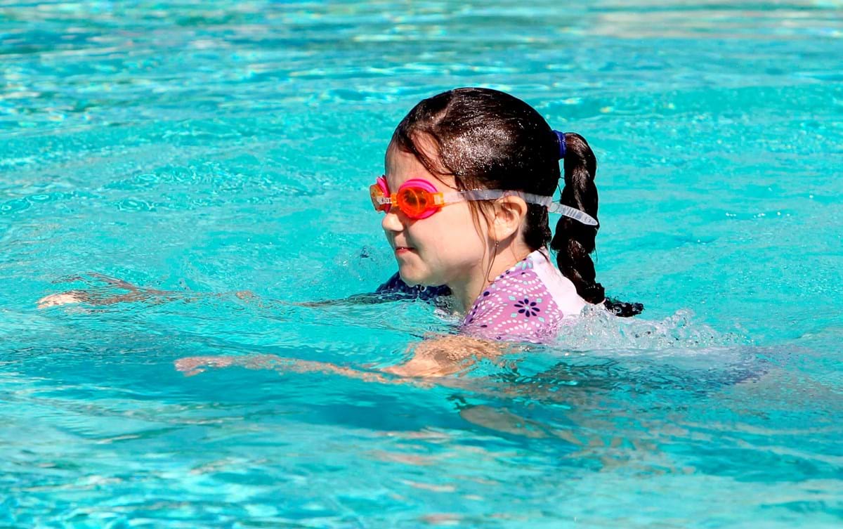 young girl swimming in the pool