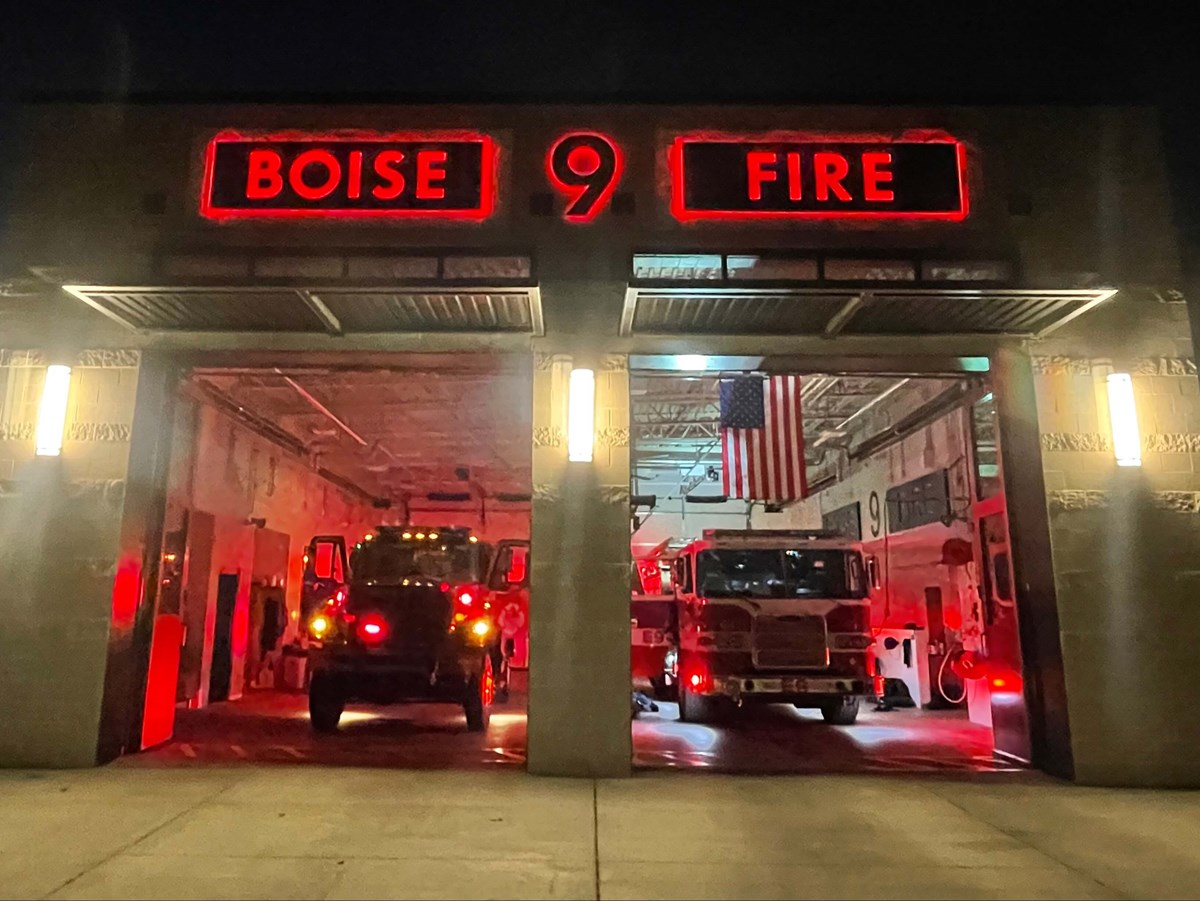 Boise Fire 9 with garage doors open and fire trucks lit up with red lights
