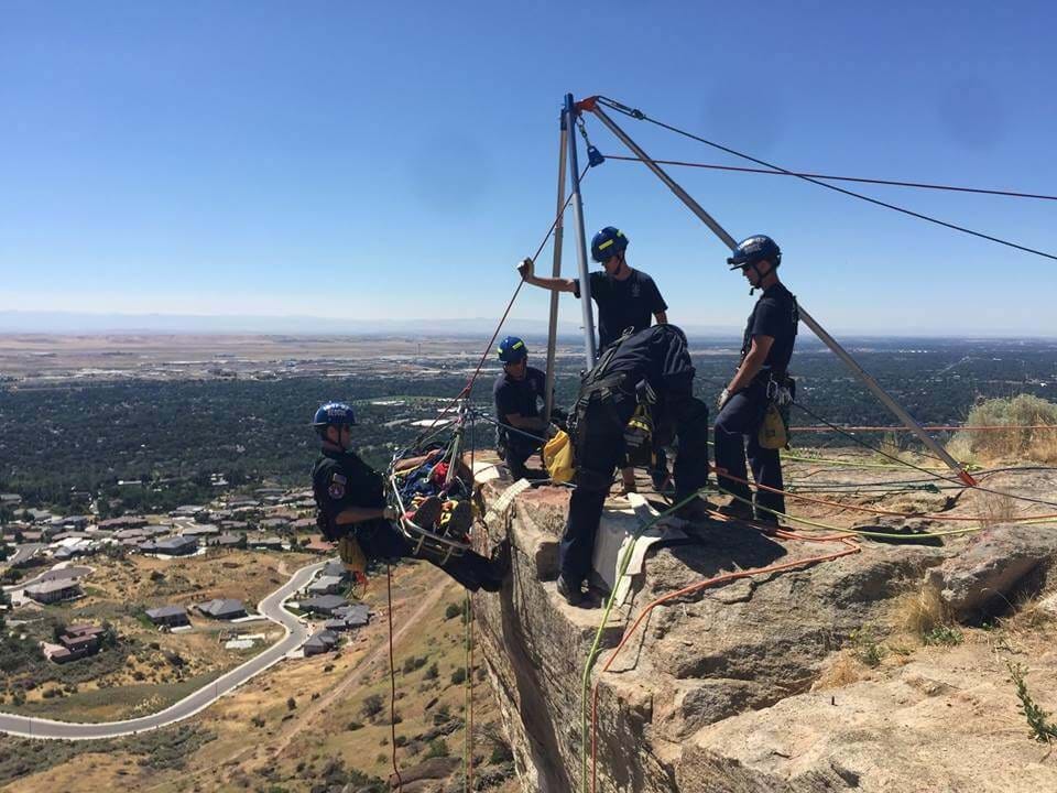 Tech rescue team scaling down a cliff