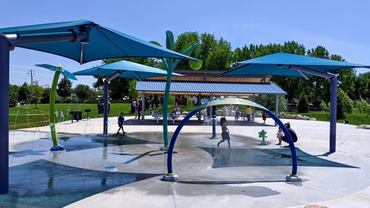 Kids enjoying the Molenaar Park splash pad on a hot summer day.