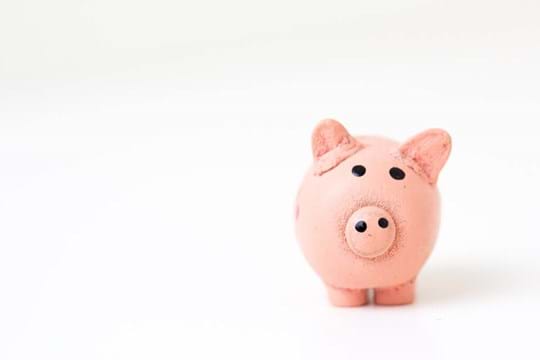 Pink pig bank with a white background