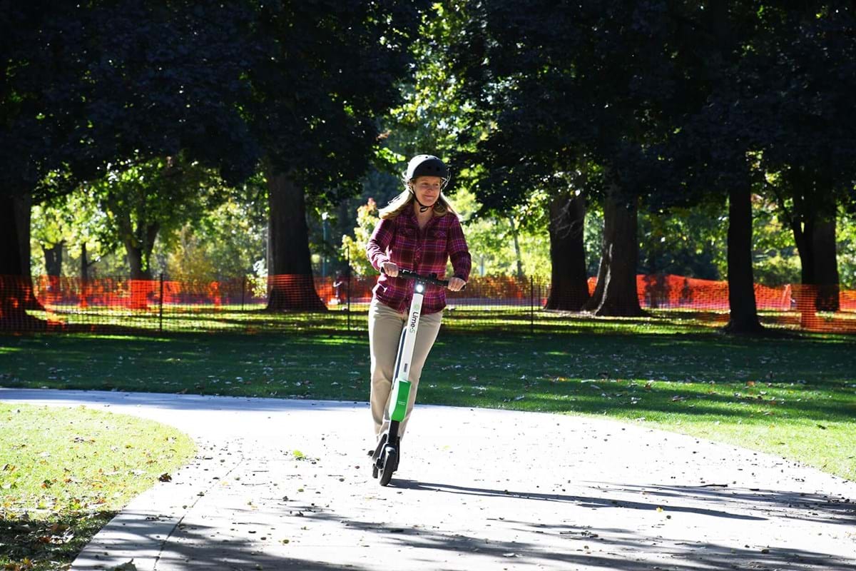 Person riding scooter on Boise pathway.
