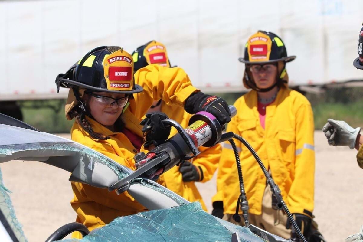 Teens getting hands-on experience with fire fighting at a Ignite bootcamp