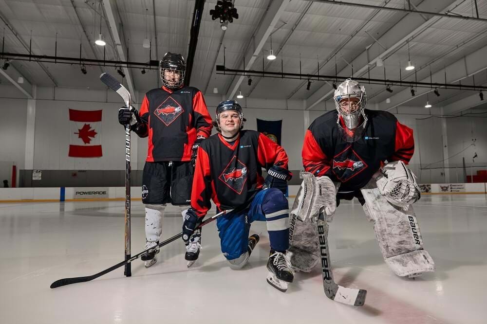 Group of three men posing for a hockey photo