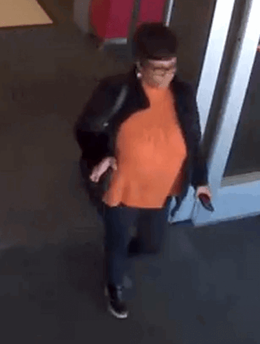 Female suspect leaving a restaurant
