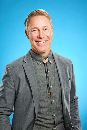 Smiling man wearing a bolo tie