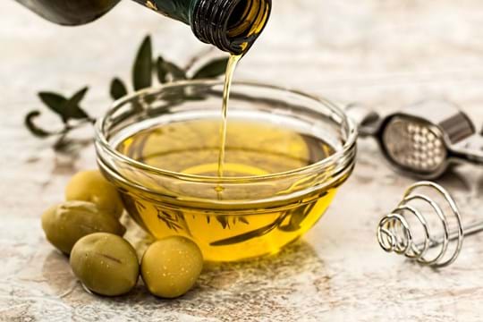 Olive oil poured into small bowl