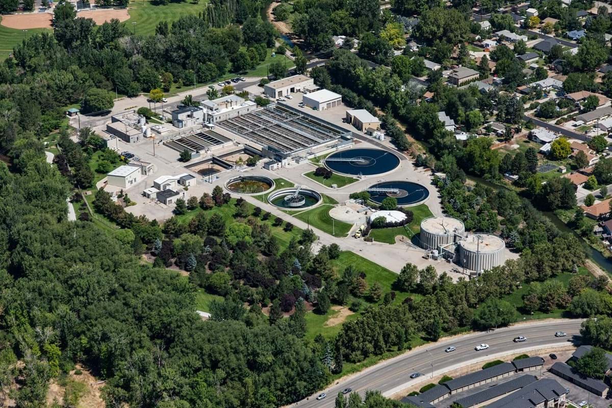 Aerial view of a water treatment facility surrounded by trees