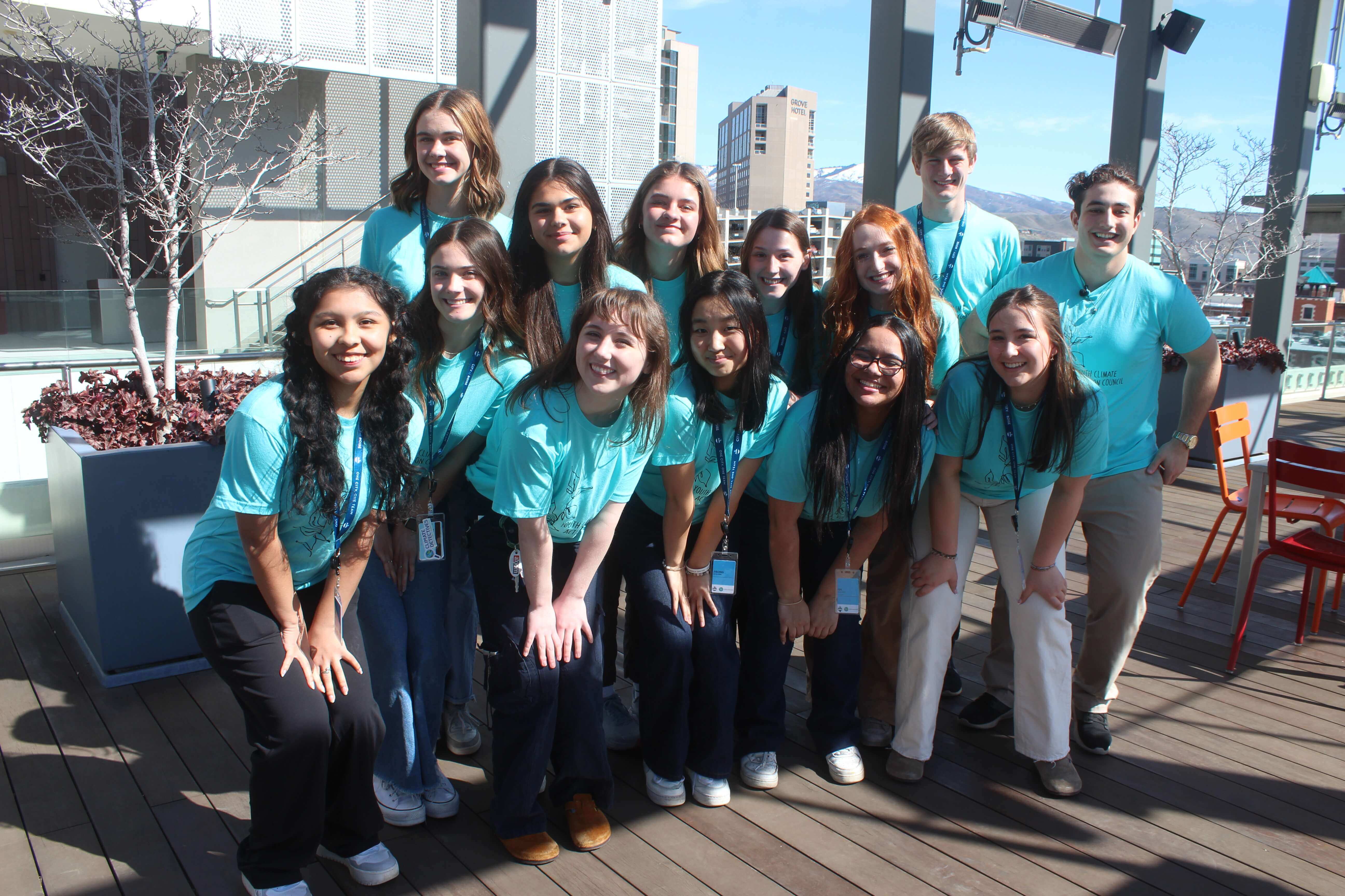 Group of youth that are all wearing light blue shirts.