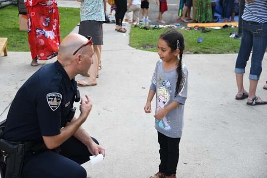 Police officer talking to little girl
