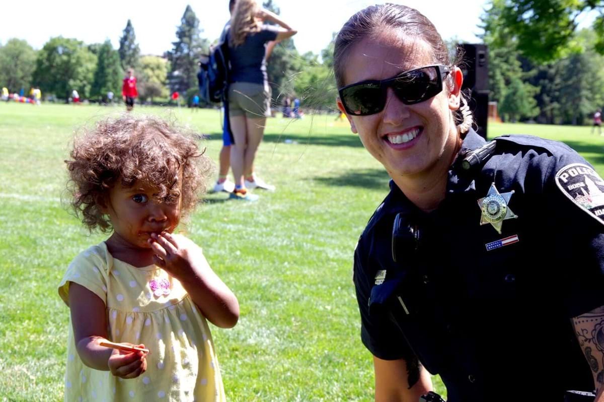 Female officer smiling with child