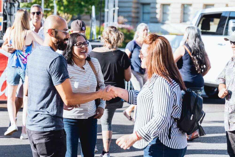 Three people meeting at LatinoFest in Boise.
