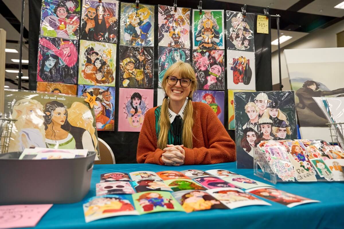 BCAF artist at booth in the Artist Alley.